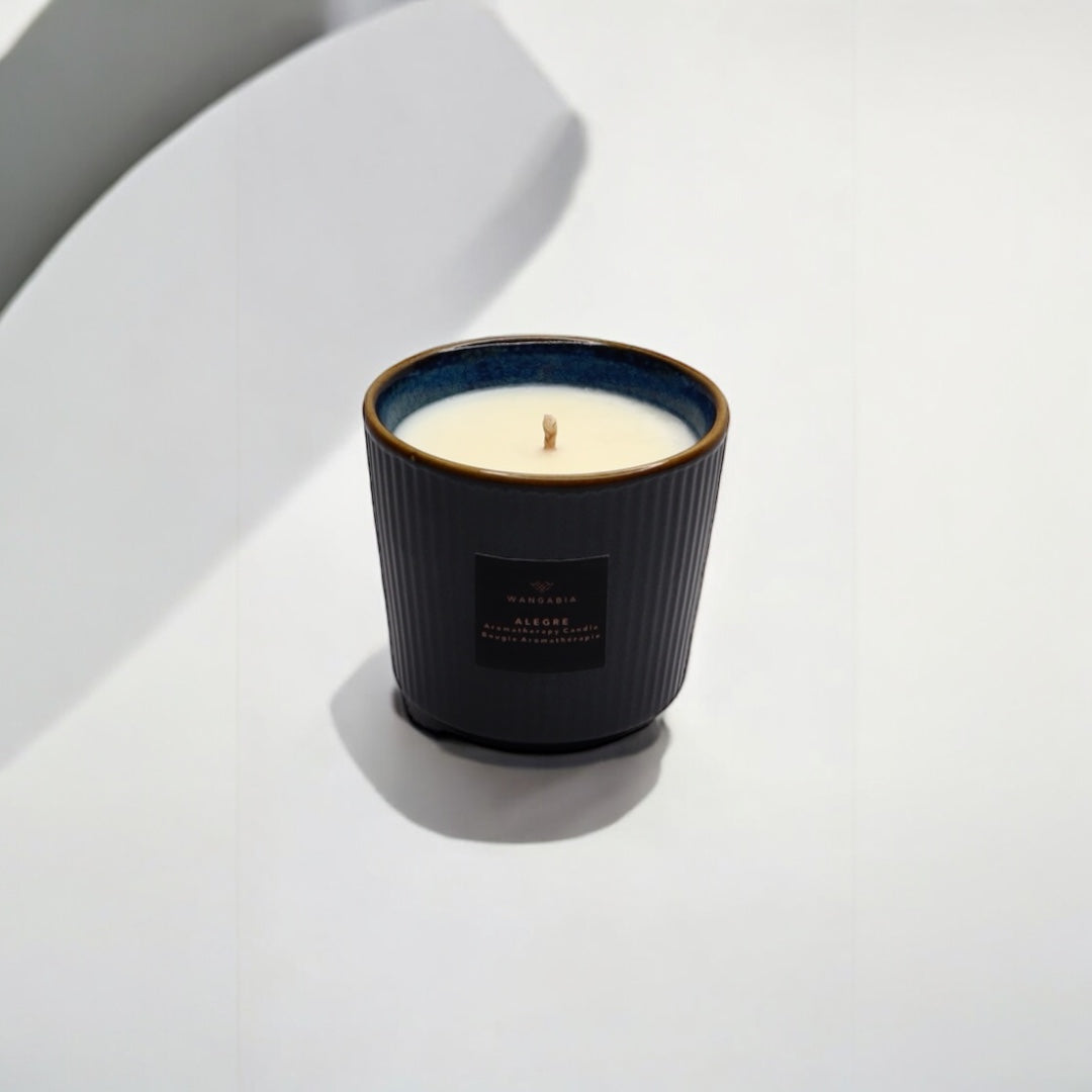 An Alegre wellness candle on a surface